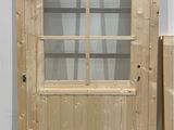 a wooden door that has a glass door in it