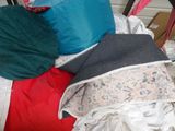 a pile of pillows and blankets on a bed