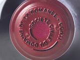a close up of a wine bottle with a red label