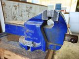 a blue vise that is sitting on a table