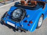 a blue sports car parked on the side of the road