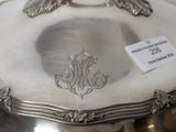 a silver plate that has a monogram on it