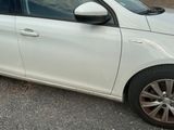 a picture of a white car parked on the side of the road