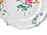 a white plate with a pink rose painted on it