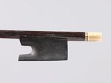 a close up of a knife with a wooden handle on a white surface