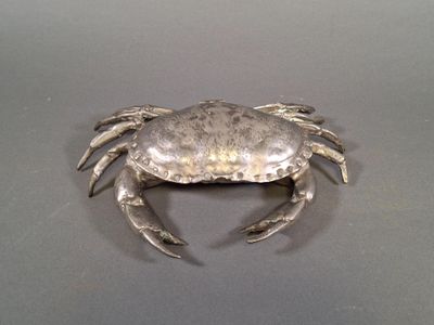 a silver crab that is sitting on a table