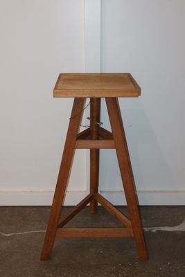 a small wooden table with a shelf on it