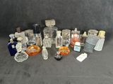 many bottles of perfume on a black surface