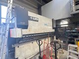 an image of a large machine in a warehouse with a ladder