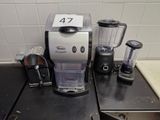 a coffee maker and blender sitting on a kitchen counter