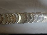 a lot of coins sitting on a table next to each other