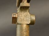 a close up of a metal pipe with a sign on it