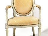 an upholstered chair with a beige upholstered seat and a beige upholstered back