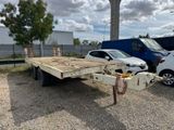 a flatbed trailer that is parked in a parking lot