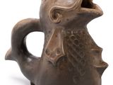 un vase marron orné d'un poisson sur un fond blanc