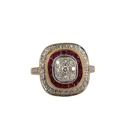 a close up of a diamond and ruby ring on a white background