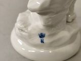 porcelain figurine of a dog with a hat on its head