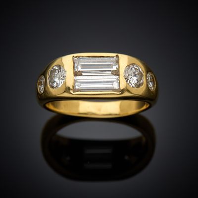 an 18k yellow gold ring with baguets and diamonds