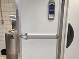 a white refrigerator with a digital display on the door