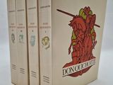 trois livres sont empilés sur une surface blanche