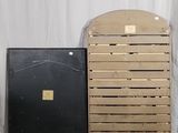 a stack of wooden crates next to a black box