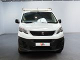 the white van is parked in a large room with a black floor