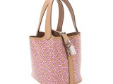 a brown and pink handbag with pink flowers on it