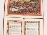 an open book with a picture of a city on it