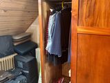 an image of a closet in a attic with luggage
