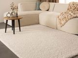 a large white rug on the floor in a living room