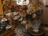 two vases that have flowers in them on a table