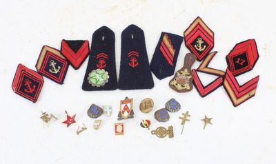 several badges and insignias are laid out on a white surface