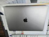 un ordinateur portable Apple argenté posé sur un bureau