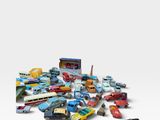 a pile of toy cars on a white surface