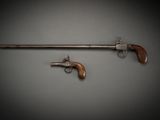 a pair of pistols with wooden grips and a wooden handle