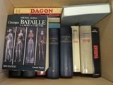 many books in a box that are sitting on top of each other