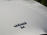 a close up of a white car with arabic writing on the hood