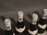 several bottles of wine are lined up on a table