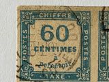 an old stamp with the number 60 on it and a stamp with the number 50 on it
