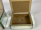 a small glass box with a mirror inside of it