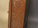 a small wooden cabinet with a flower design on it