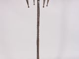 an image of a metal candelab with four candles on a stand