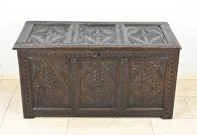 an old wooden chest with carvings on the top of it