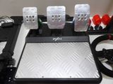 a picture of a laptop with four pedals and a steering wheel