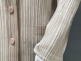 a close up of a mannequin wearing a beige sweater and black pants