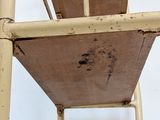 a wooden chair with a metal frame and a seat on it