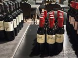 bottles of wine are lined up on a table in a restaurant