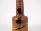 a brown vase with a black bird on it