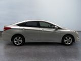 the silver car is parked on the concrete floor in the room