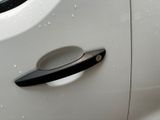 a close up of a door handle on a white car